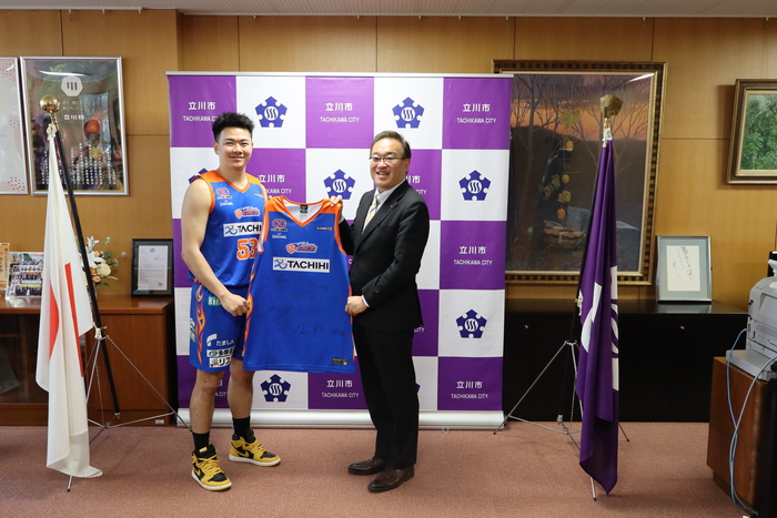 ユニフォームを受け取る酒井市長